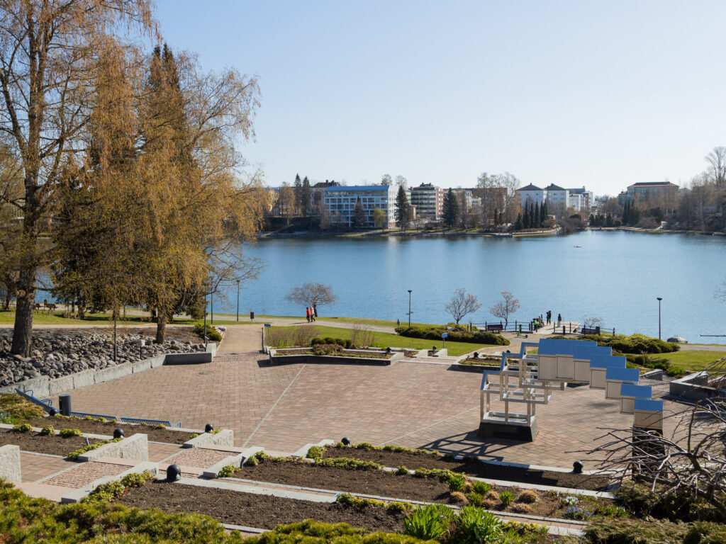 Valkeisenlammen Ruusupuiston kivetetty portaikko keävällä, taustalla Valkeisenlampi