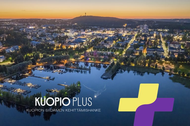 KuopioPlus, taustalla öinen Kuopio
